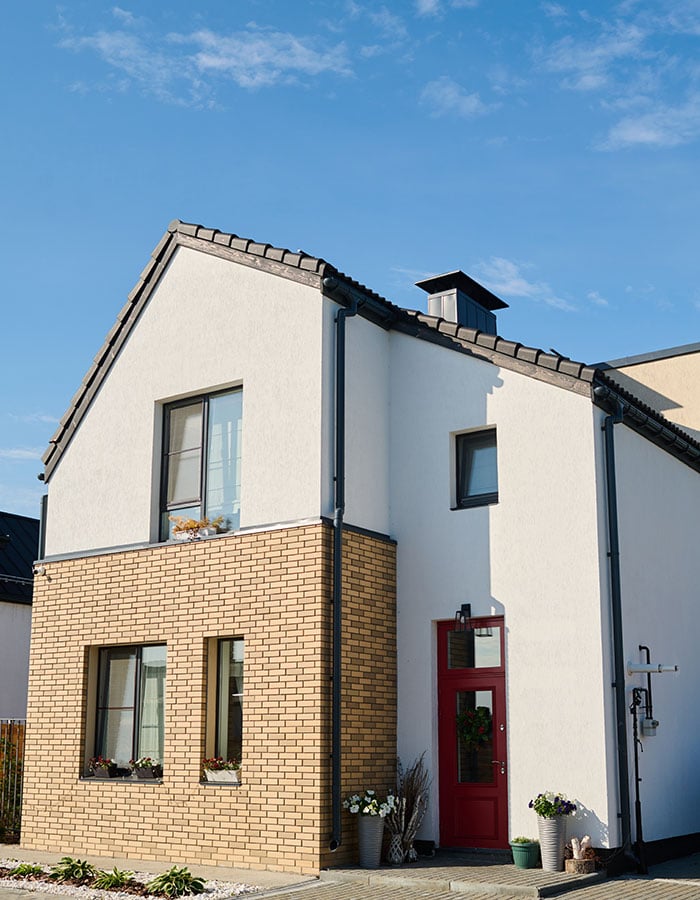 facade of small white cottage with three windows a DYPUD6V